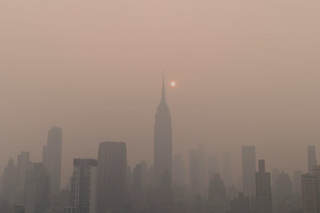Thick smog over a city skyline during Lahore's winter smog season